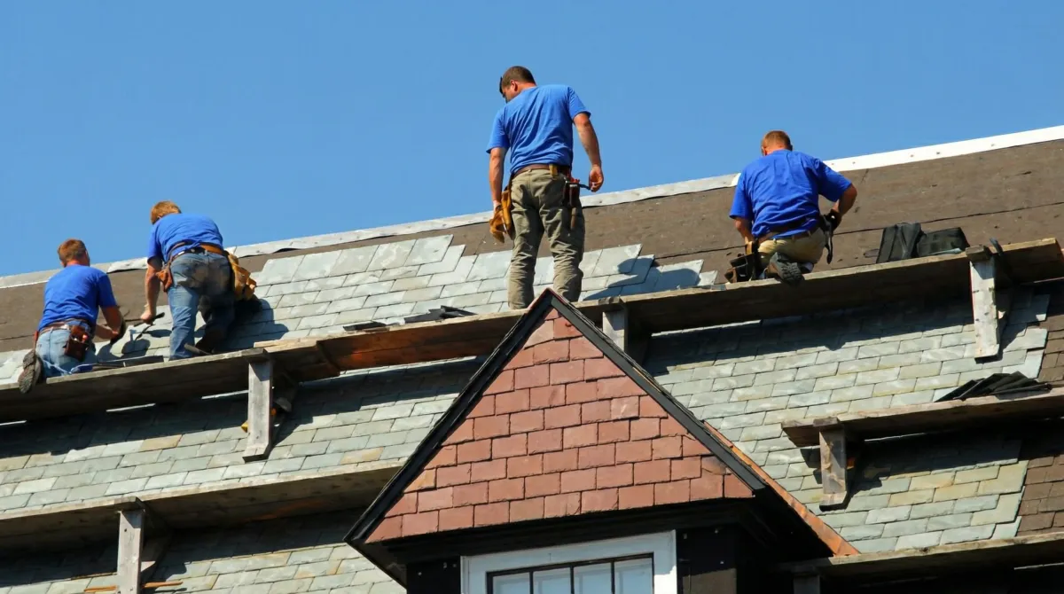 Roof replacement in progress with a team of professional contractors installing new shingles on a residential home in Henderson, NV